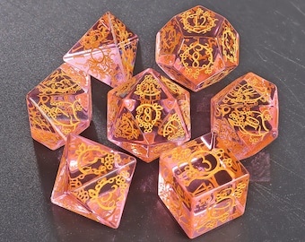 May include: Set of six pink and gold dice with intricate designs. Each die has a different number on each side.