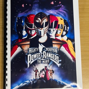 May include: A poster for the movie "Mighty Morphin Power Rangers: The Movie" featuring the Power Rangers in their helmets against a starry background. The movie title is prominently displayed. The poster is bound with a black spiral.
