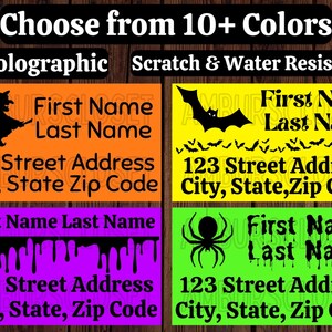 May include: Four colorful Halloween-themed address labels. Each label features a different design: a witch on a broom, bats, dripping blood, and a spider. The labels include space for a name and address, with the text "Choose from 10+ Colors", "Holographic", and "Scratch & Water Resistant".