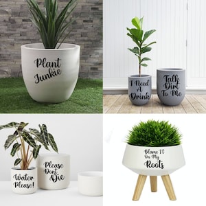 May include: A selection of decorative plant pots, each containing a plant. The pots are in shades of white and grey, with humorous text such as "Plant Junkie" and "Blame It On My Roots." The pots vary in shape and size, suitable for indoor or outdoor use.
