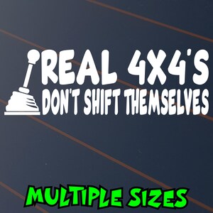 May include: White decal with the text "REAL 4X4'S DON'T SHIFT THEMSELVES" and a gear shift graphic. The words "MULTIPLE SIZES" are in green at the bottom. The background is dark blue with brown diagonal lines.