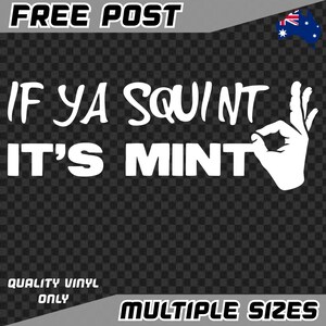 May include: White vinyl sticker with the text "IF YA SQUINT IT'S MINT" and a hand gesture. The sticker also includes the words "FREE POST", "QUALITY VINYL ONLY", and "MULTIPLE SIZES". The background is a checkered pattern.