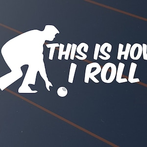 May include: White silhouette of a person bowling, with the text "THIS IS HOW I ROLL" in white. The image is set against a dark blue background with diagonal brown lines.
