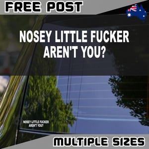 May include: A black car window sticker with the text "NOSEY LITTLE FUCKER AREN'T YOU?" in white. The words "FREE POST" and "MULTIPLE SIZES" are also visible. An Australian flag is in the upper right corner.