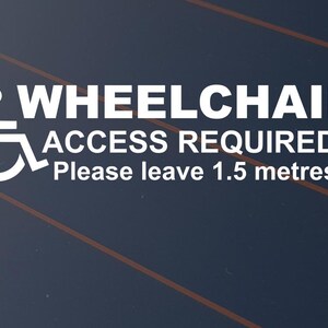 May include: White sign indicating wheelchair access requirements. The text reads "WHEELCHAIR ACCESS REQUIRED Please leave 1.5 metres" with a wheelchair symbol. Set against a dark blue backdrop with orange diagonal lines.