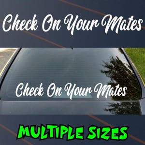 May include: White vinyl decal with the text "Check On Your Mates" in a cursive font. The decal is shown on a car window. The bottom of the image has the text "MULTIPLE SIZES" in green.