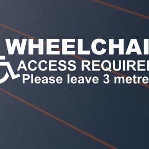 May include: White wheelchair access sign with the words "WHEELCHAIR ACCESS REQUIRED" and "Please leave 3 metres" on a dark blue background with diagonal orange lines. The sign includes the universal wheelchair symbol.