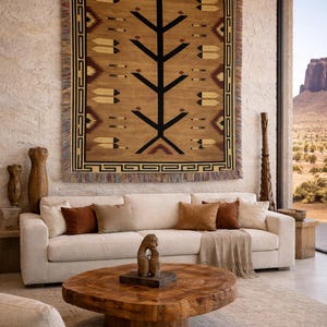 May include: A living room featuring a large, tan woven tapestry with a tree design above a white sofa with brown cushions. A wooden coffee table and decorative items complete the scene.