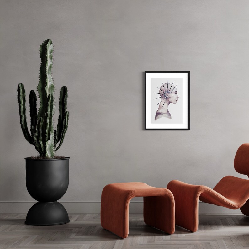 May include: A framed watercolor illustration of a person with a spiky, geometric design on their head. The person is looking to the right and has a neutral expression. The background is a light gray.