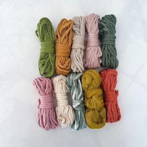 May include: Assortment of 10 colorful cotton cords, including green, orange, beige, pink, red, and white. The cords are bundled together and arranged in a row.
