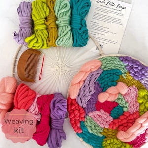 May include: A colourful yarn weaving kit with a wooden loom, comb, and yarn in shades of pink, purple, green, yellow, and blue. The kit includes instructions for creating a wall hanging. "Lush Little Loops" and "Candy Rainbow Weaving Kit" are printed on the instructions.
