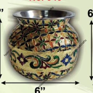 May include: A 6-inch tall, round, silver metal pot with a gold base and colourful floral designs. The pot is decorated with intricate patterns and has a shiny finish.