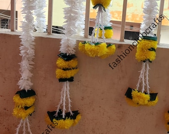 May include: White and yellow flower garlands with green accents hanging on a wall. The garlands are labeled "fashionclubcrafts" and "onclubcrafts".