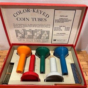 May include: A vintage coin tube kit with a red box and lid. Inside are orange, red, green, white, and blue coin tubes. The lid has text that reads "COLOR-KEYED COIN TUBES" and a parts list.