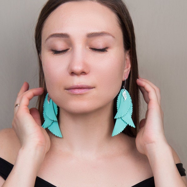 Pastel Turquoise leather feathers earrings with small pendant wings