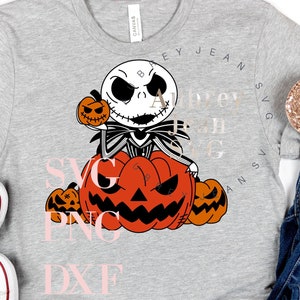 May include: A gray t-shirt with a graphic of Jack Skellington from The Nightmare Before Christmas holding a pumpkin. The text "SVG PNG DXF" is printed on the shirt in pink.