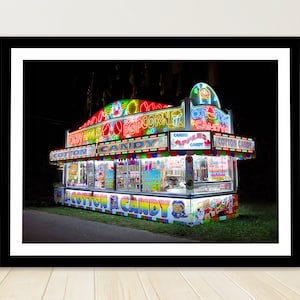 May include: A brightly lit carnival food stand with neon signs that read 