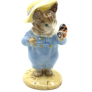 May include: A set of three ceramic mugs with a speckled, matte finish. The mugs are in shades of cream, light brown, and dark brown. Each mug has a simple, minimalist design, perfect for coffee or tea.