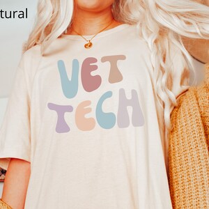 May include: A white t-shirt with the text "VET TECH" in colorful, retro-style lettering.