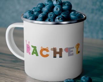 May include: White enamel mug with a black rim and handle. The mug has the name "Rachel" spelled out in colorful letters with animal illustrations. The letters are decorated with a bunny, alligator, fox, horse, elephant, and giraffe.