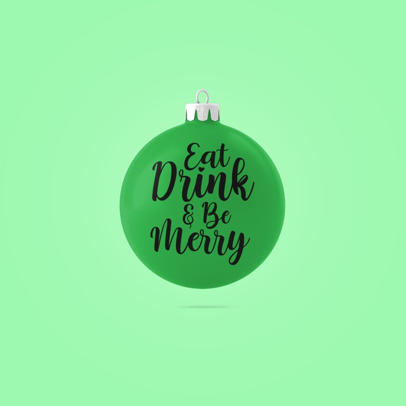 May include: Green Christmas ornament with the text "Eat Drink & Be Merry" in black cursive lettering.