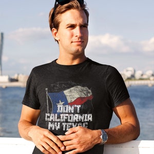 May include: A black t-shirt with a distressed graphic of the Texas flag and the text "Don't California My Texas".