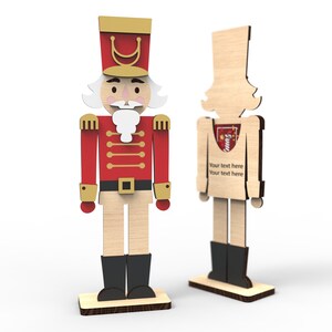 May include: Two wooden nutcracker figures, one in a red and gold uniform and the other in a plain wood design. The plain wood figure has the text "Your text here Your text here" on the front.