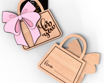 May include: Wooden gift card holder shaped like a purse with a pink bow and the words "for you" on the front. The back of the holder has a blank space for a message and the word "from".