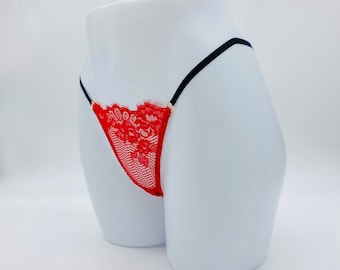 May include: Red lace lingerie with black straps and gold accents.