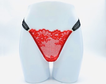 May include: Red lace underwear with black trim and gold accents.