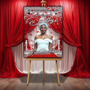 May include: A red carpet backdrop with silver glitter and red rose petals. The backdrop features a photo of a woman in a white dress with the text "Welcome to Dorothy's 60th Birthday".