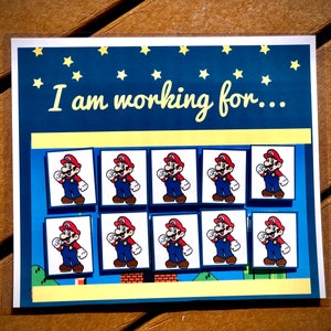 May include: A blue and yellow card with the text "I am working for..." and nine images of Mario, a video game character, in a red and blue suit.