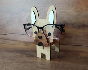 Könnte beinhalten: Brillenhalter aus Holz in Form eines Hundes mit einer schwarzen Brille auf dem Gesicht.