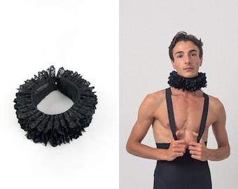 May include: A black lace ruffle collar with a black fabric backing. The collar is shown on a white background.