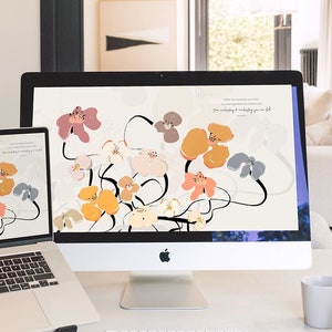 May include: Two computer screens displaying a floral desktop background with abstract flowers in shades of pink, orange, yellow, and gray. The text on the screen reads "Don't make the mistake of thinking that just because you are struggling, you are failing. You are evolving and unfolding, you are full of possibility."