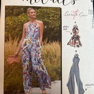 May include: McCall's sewing pattern M8069 for a halter-neck jumpsuit with a fabric belt. The pattern envelope features a light blue jumpsuit with a tropical leaf print in shades of pink, yellow, and dark blue, alongside technical sketches for variations.