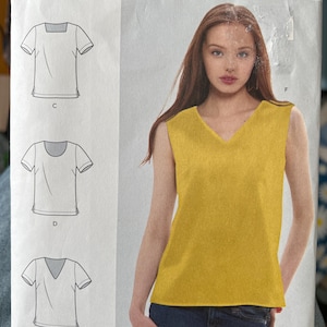 May include: A Simplicity sewing pattern envelope S9133 for sizes 8-16. The front displays a yellow sleeveless V-neck top and line drawings of three short-sleeved shirt variations labelled C, D, and E. The text includes Simplicity, S9133, and size information.