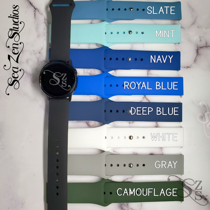 May include: A black smartwatch with a variety of colored silicone watch bands. The bands are labeled with the colors: Slate, Mint, Navy, Royal Blue, Deep Blue, White, Gray, and Camouflage.