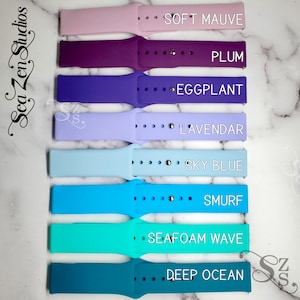 May include: Eight silicone watch bands in different colors, including soft mauve, plum, eggplant, lavender, sky blue, smurf, seafoam wave, and deep ocean. The bands are arranged vertically, with the color names printed next to each band.