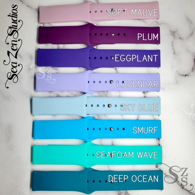 May include: Eight silicone watch bands in different colors, including soft mauve, plum, eggplant, lavender, sky blue, smurf, seafoam wave, and deep ocean. The bands are arranged vertically, with the color names printed next to each band.