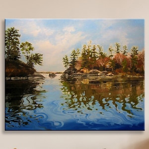 May include: A painting of a lake scene with a small island in the middle. The island is covered in trees and there are reflections of the trees in the water. The water is a light blue color and the sky is a light blue color with some white clouds.