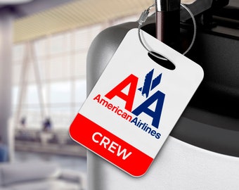 May include: A white luggage tag with a red and blue American Airlines logo and the word "CREW" in red letters.