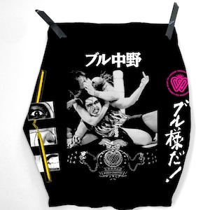 May include: Black graphic tee with a grayscale wrestling illustration. The shirt features Japanese text and a logo for All Japan Women's Pro-Wrestling. The tee is suspended against a white backdrop.