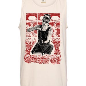 May include: Cream-colored tank top featuring a red and black graphic. The graphic depicts a person holding a gun, surrounded by skulls and mushroom cloud explosions. The design has a vintage, distressed aesthetic.