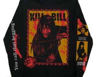 May include: Black long-sleeve shirt featuring a graphic from the movie "Kill Bill." The design includes a central image of a woman with the text "Kill Bill" in a yellow and red frame. The left sleeve reads "You call that begging?"