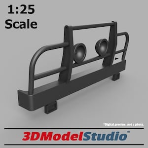 May include: A black 1:25 scale model car bumper with a metal grille and two round lights. The bumper is designed for off-road vehicles and has a rugged look.