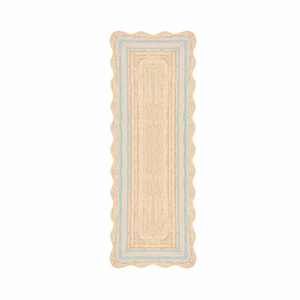 May include: A rectangular runner rug made of natural tan woven fibers featuring a scalloped edge and a light blue border accent. The design consists of a central rectangular panel surrounded by a matching light blue frame on a textured surface.