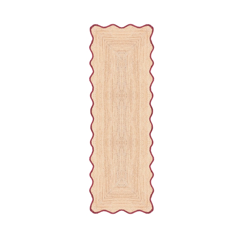 Puede incluir: Una alfombra rectangular tipo pasillo hecha de fibras tejidas en color tostado natural. La alfombra presenta un borde festoneado distintivo en color rojo intenso que sigue todo el per&iacute;metro de la pieza, creando un contorno ondulado.