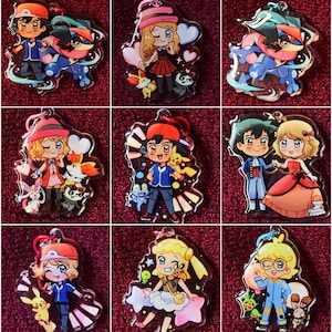 May include: Nine different Pokemon character keychains featuring various characters from the Pokemon anime series. The keychains are made of clear acrylic and feature colorful illustrations of the characters.
