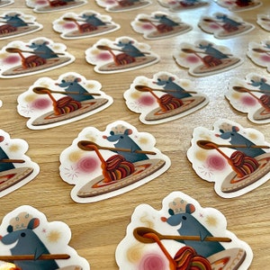 May include: A set of 10 stickers featuring a cartoon mouse wearing a chef's hat and holding a spoon over a bowl of spaghetti. The stickers are printed on white, glossy paper and have a rounded rectangular shape.
